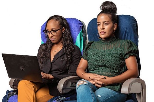 Two women pose with Slumber Bliss antimicrobial seat covers.